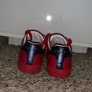 Red low top Gucci sneakers